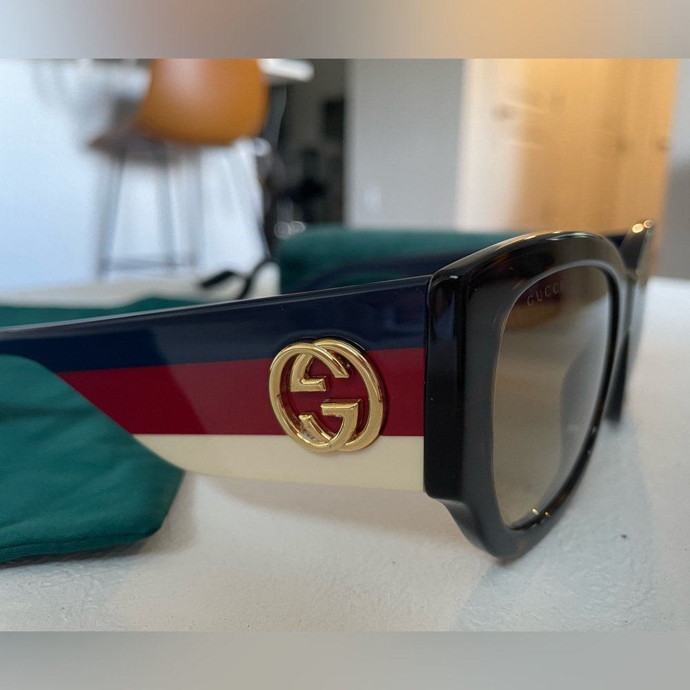 GUCCI sunglasses. Tortoise frames with blue, white and red side stripes. Gold GC